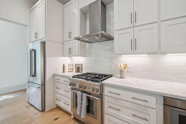 a kitchen with granite countertop cabinets stainless steel appliances and a counter space