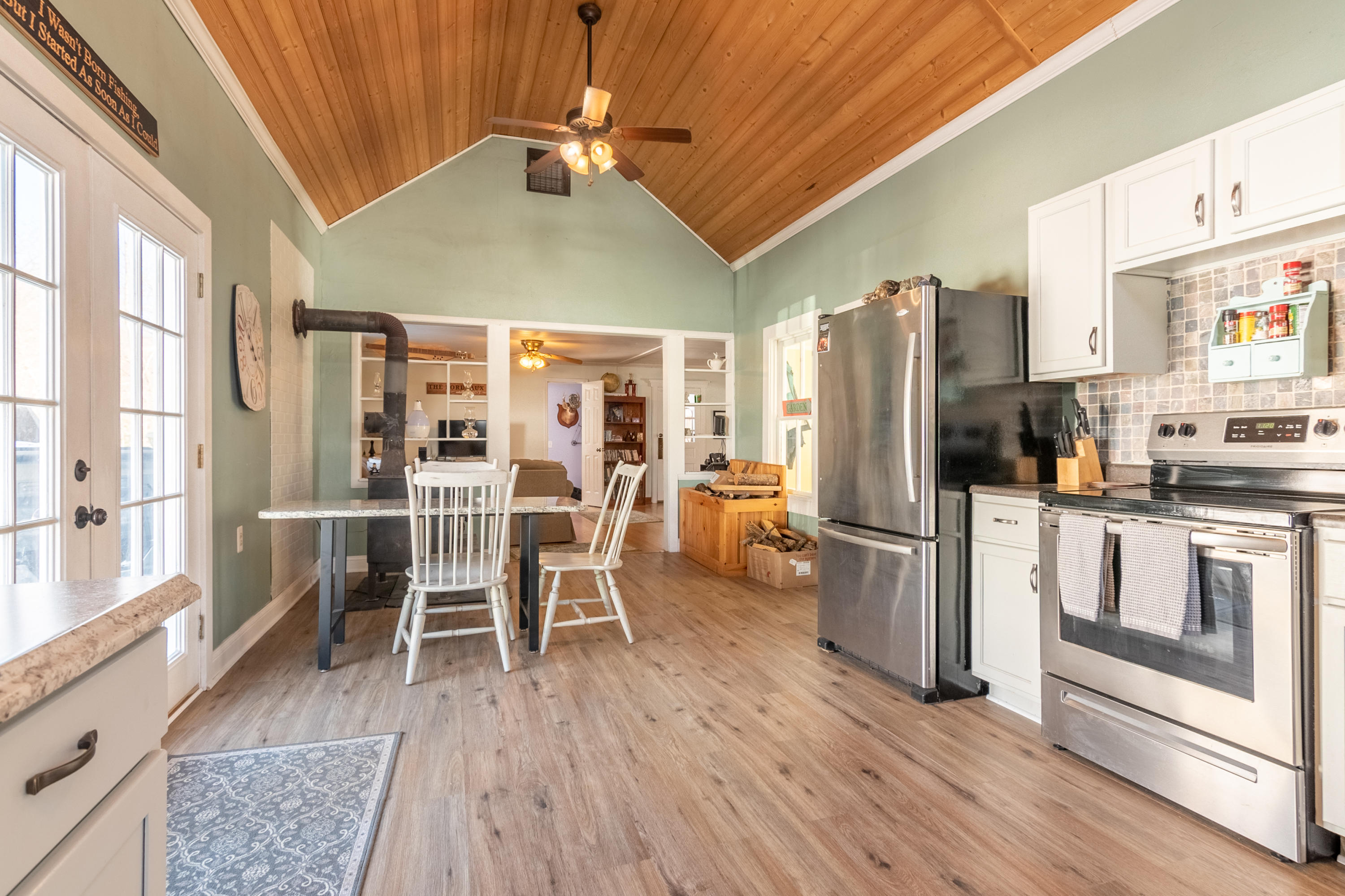 1696 Conner Grove Road Southwest Willis, VA 24380 - Photo 16 of 41 a kitchen with stainless steel appliances a refrigerator stove and wooden floor