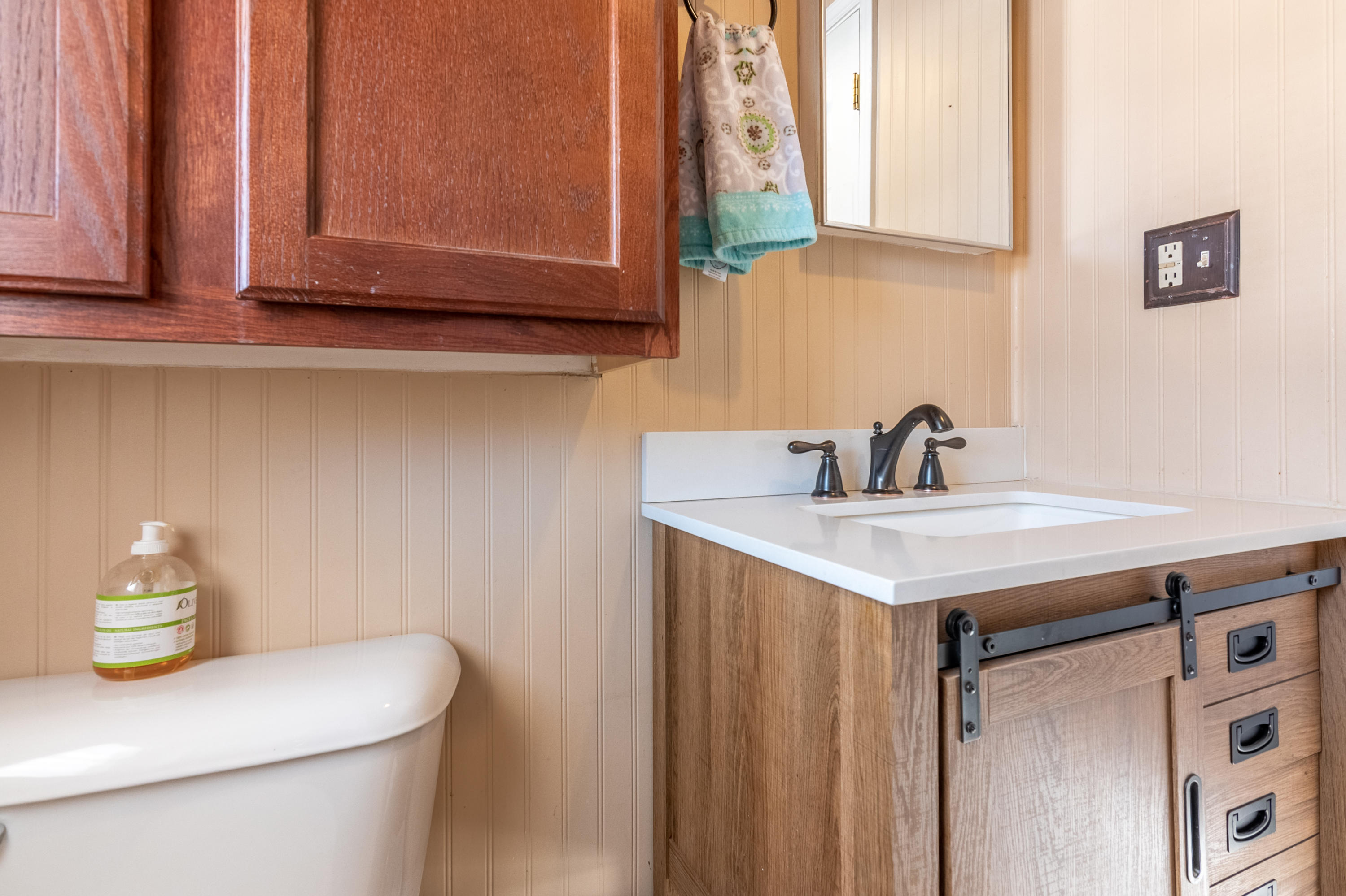 1696 Conner Grove Road Southwest Willis, VA 24380 - Photo 17 of 41 a bathroom with a sink a toilet and mirror