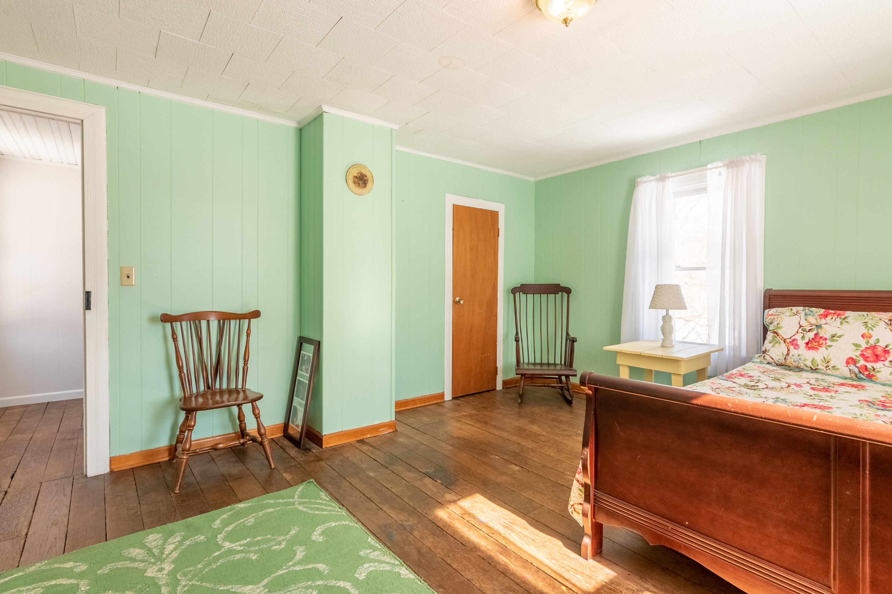 1696 Conner Grove Road Southwest Willis, VA 24380 - Photo 30 of 41 a bedroom with a bed and wooden floor