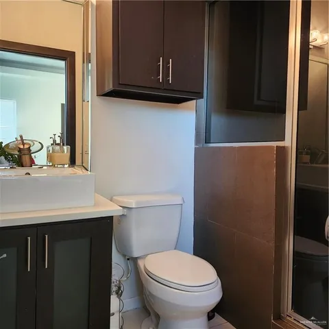 a bathroom with a sink a toilet and mirror