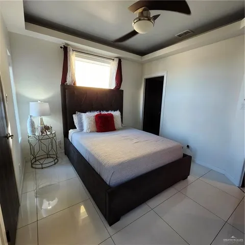 a bedroom with a bed and a mirror