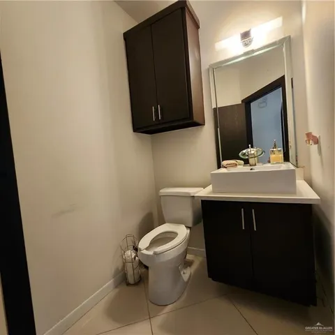 a bathroom with a sink toilet and mirror