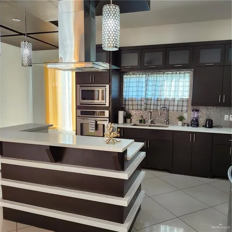 a kitchen with a sink appliances and cabinets