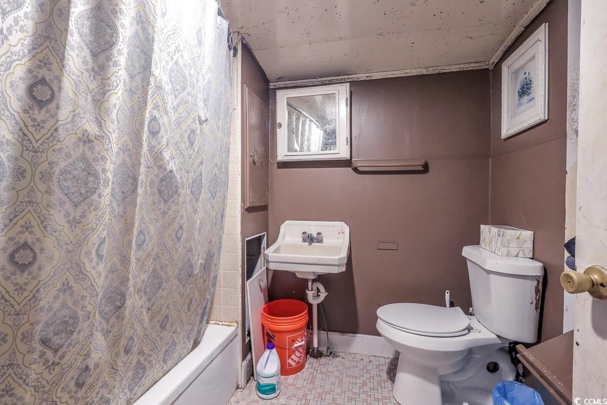 213 North Magnolia Avenue Andrews, SC 29510 - Photo 13 of 20 Full bath with tile patterned flooring and shower / tub combo with curtain