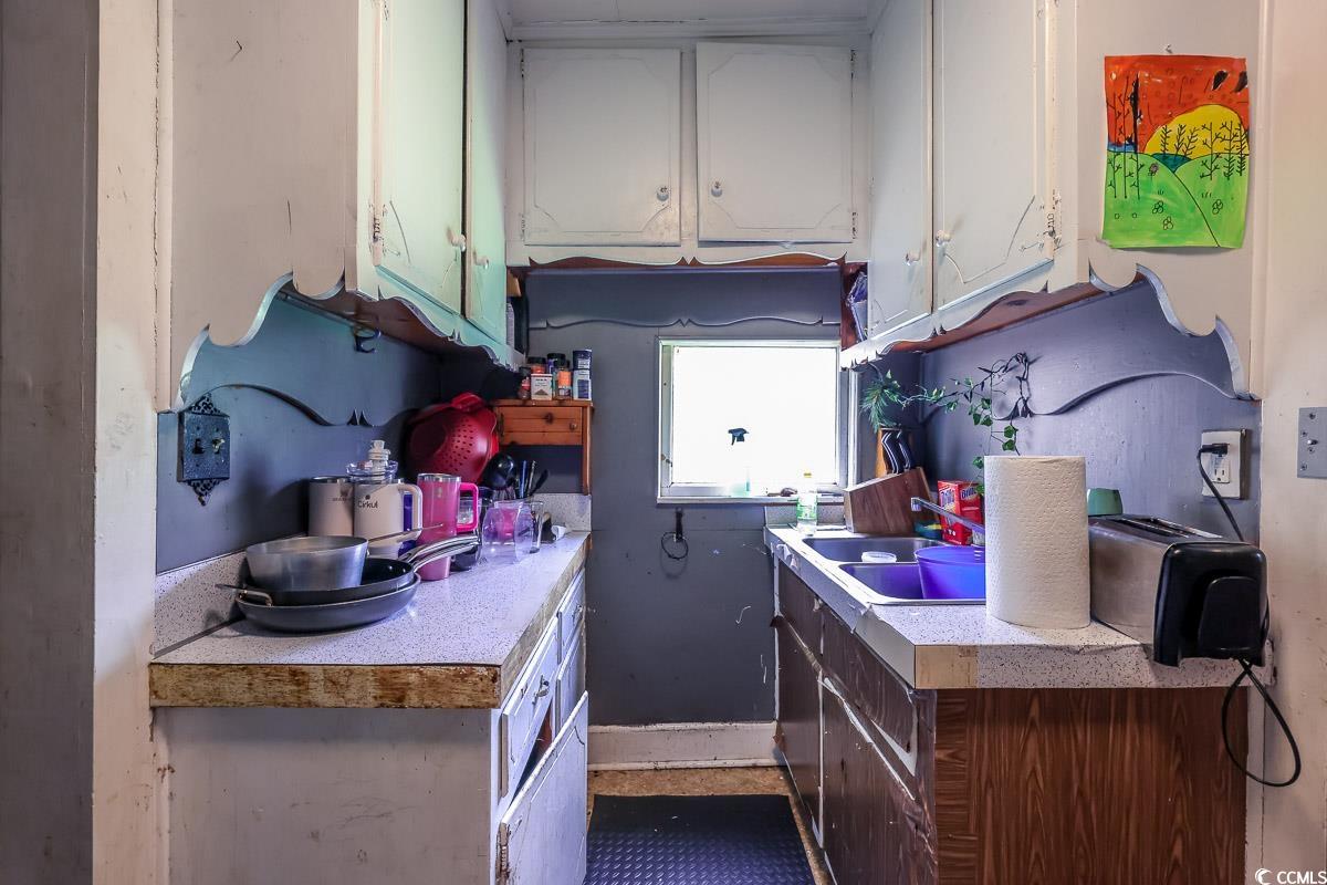 213 North Magnolia Avenue Andrews, SC 29510 - Photo 6 of 20 Kitchen with white cabinets and light countertops