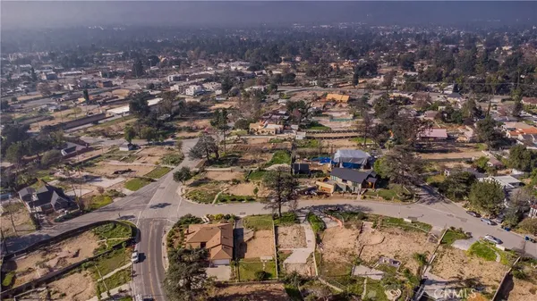 an aerial view of a house a yard and parking