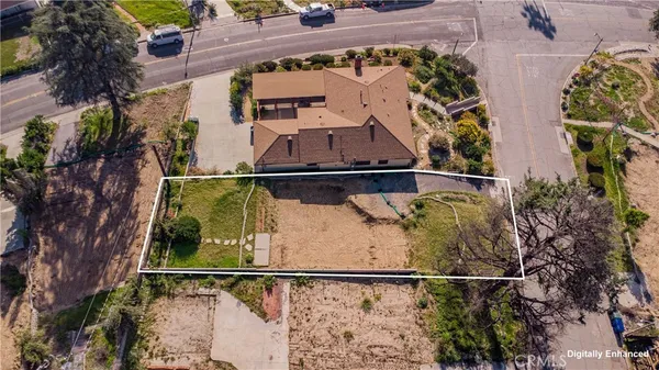 an aerial view of a house with a yard