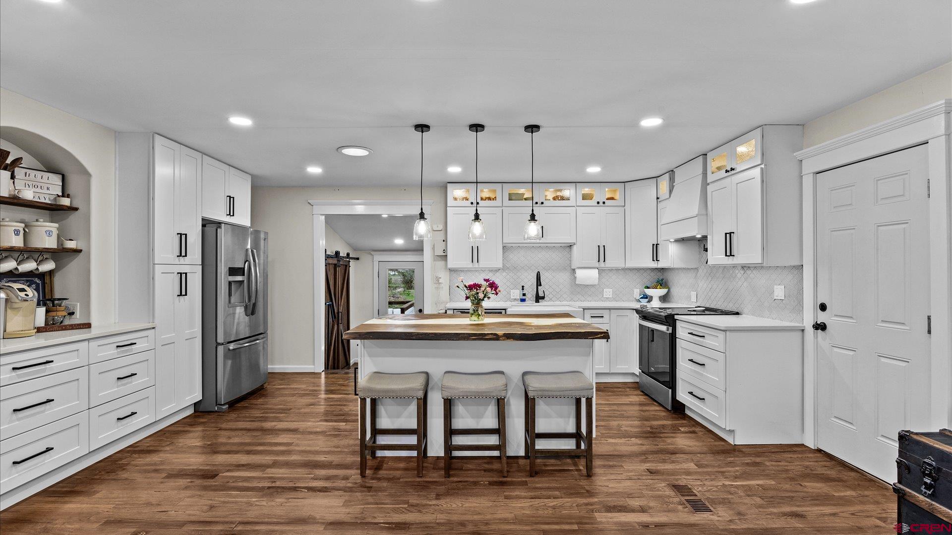 1761 G Road Delta, CO 81416 - Photo 4 of 43 a kitchen with stainless steel appliances kitchen island granite countertop a table chairs refrigerator and cabinets