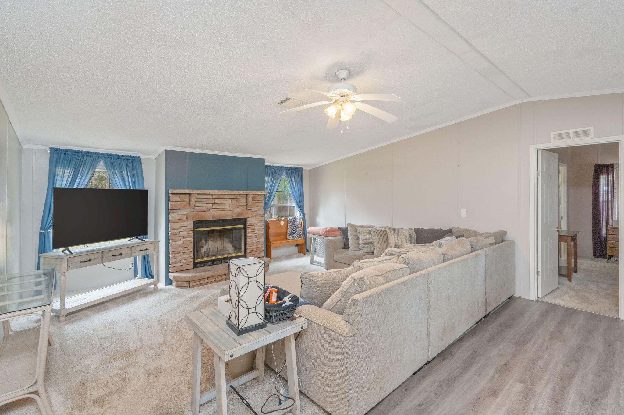 6918 Bill Lundy Road Laurel Hill, FL 32567 - Photo 13 of 27 a living room with furniture a flat screen tv and a fireplace