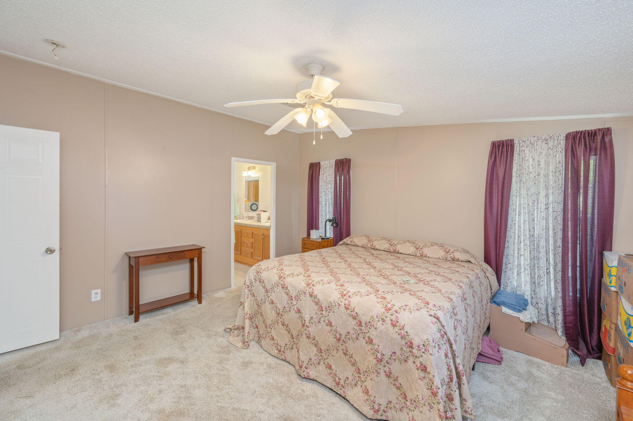 6918 Bill Lundy Road Laurel Hill, FL 32567 - Photo 18 of 27 a bedroom with a bed and a chandelier