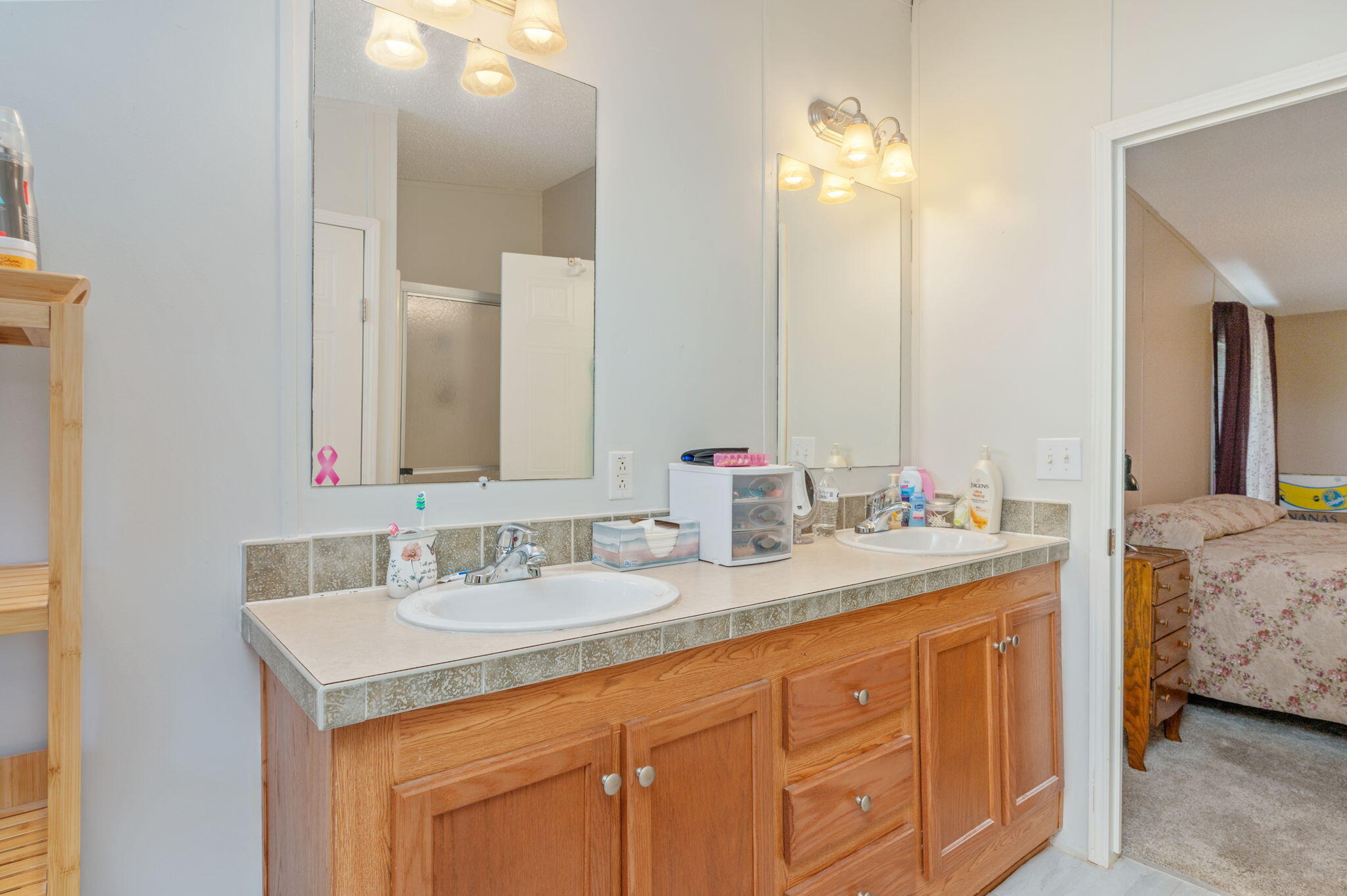 6918 Bill Lundy Road Laurel Hill, FL 32567 - Photo 20 of 27 a bathroom with a sink double vanity and a mirror