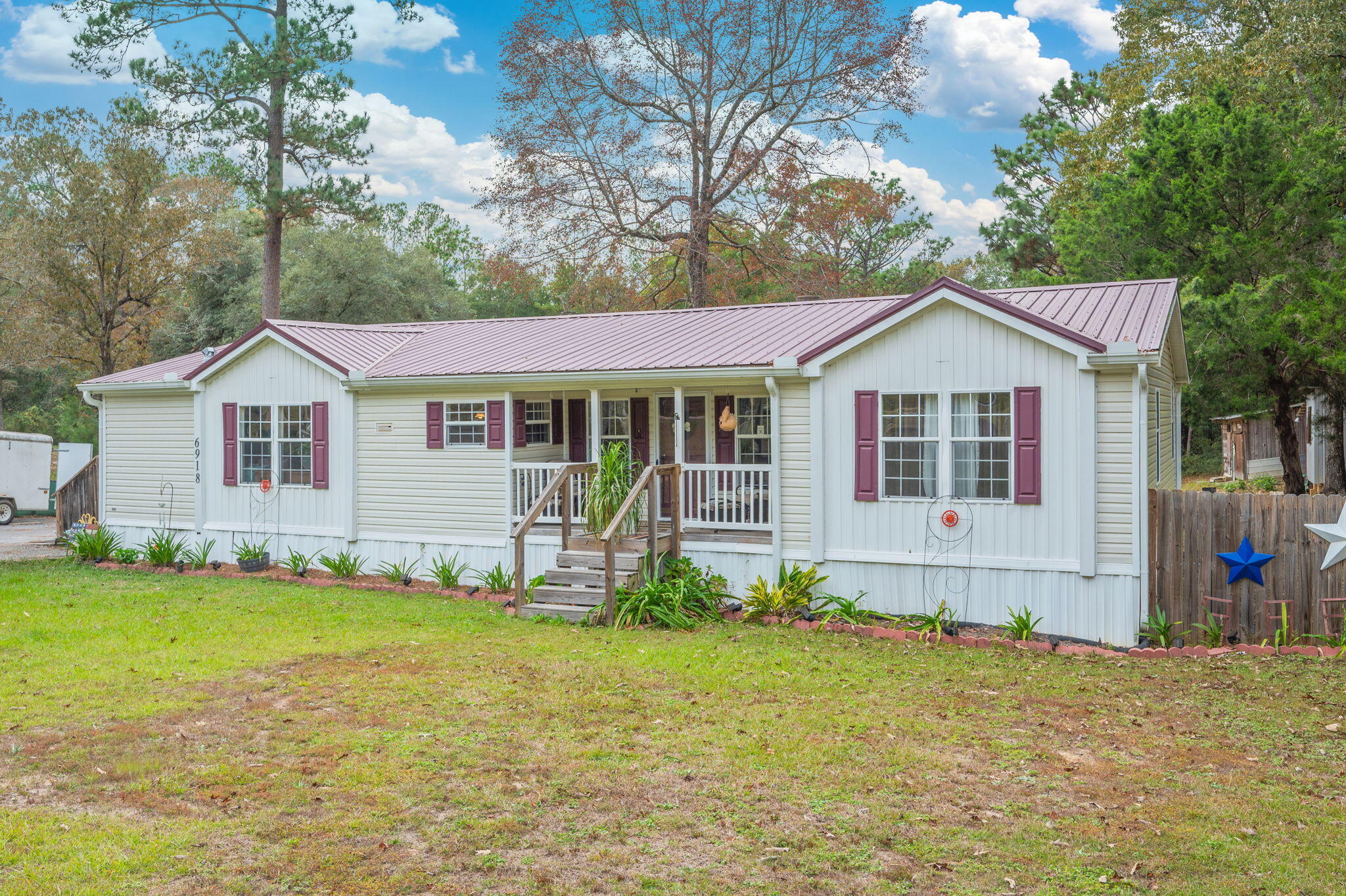 6918 Bill Lundy Road Laurel Hill, FL 32567 - Photo 2 of 27 a front view of a house with a yard