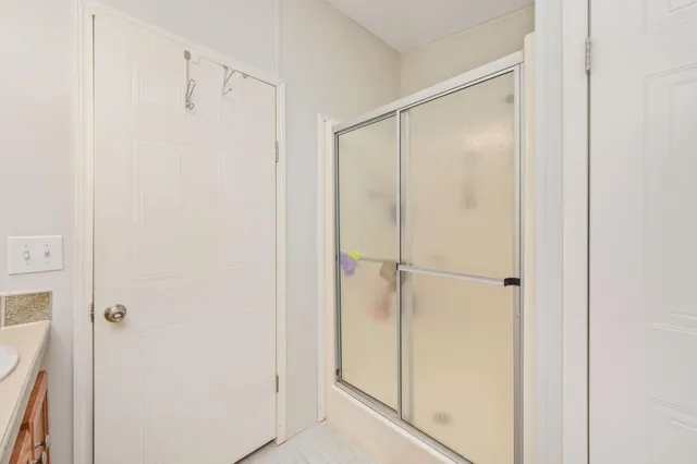 a bathroom with a glass shower door