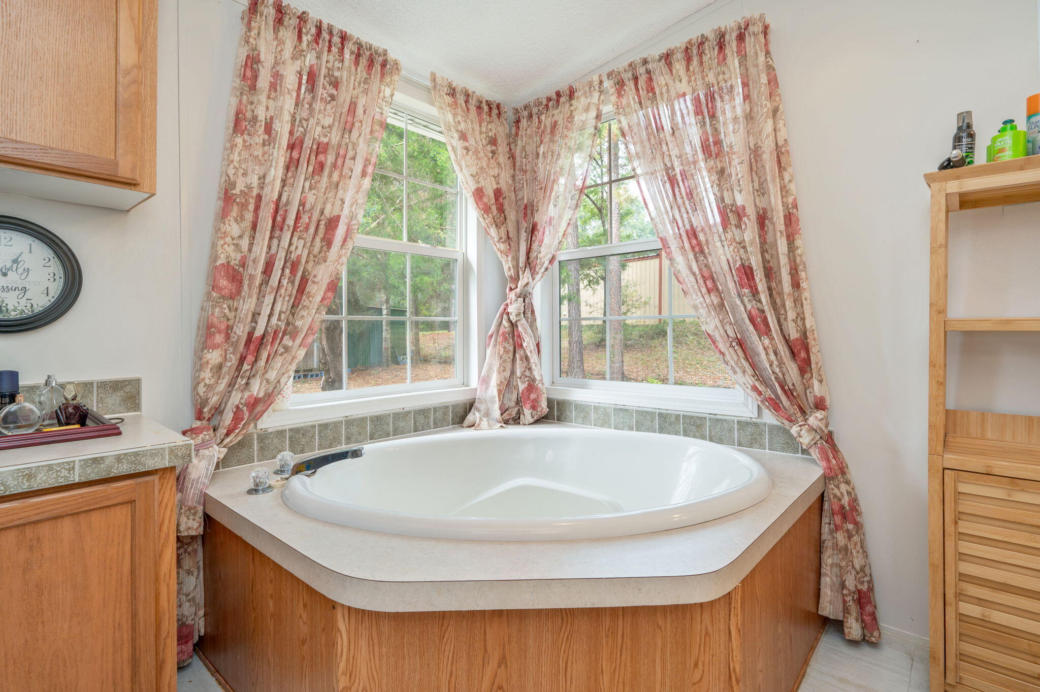 6918 Bill Lundy Road Laurel Hill, FL 32567 - Photo 22 of 27 a bathroom with a tub and large window
