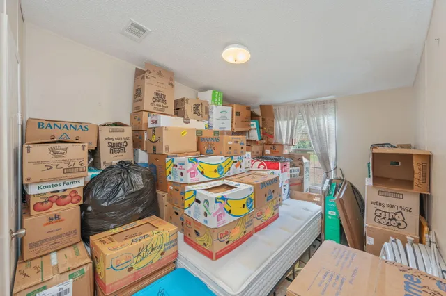 a bedroom with furniture and a wooden floor