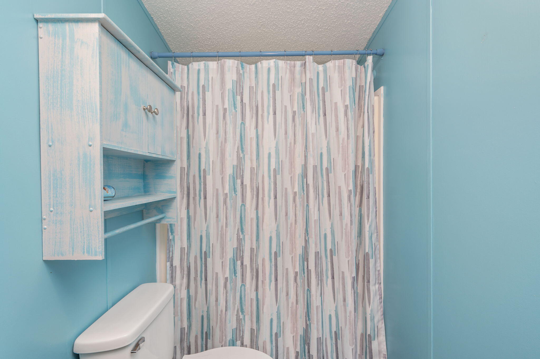 6918 Bill Lundy Road Laurel Hill, FL 32567 - Photo 27 of 27 a bathroom with a toilet and a shower curtain