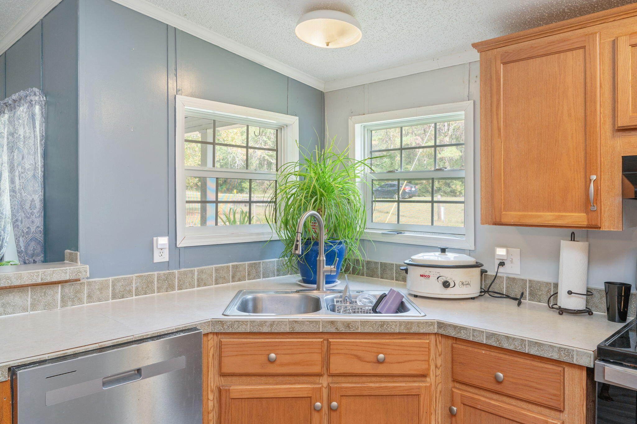 6918 Bill Lundy Road Laurel Hill, FL 32567 - Photo 7 of 27 a kitchen with stainless steel appliances granite countertop a sink a window and cabinets