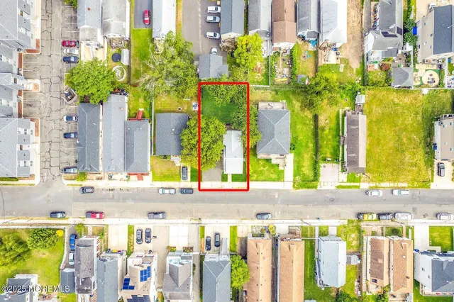 a front view of house with yard and trees in the background
