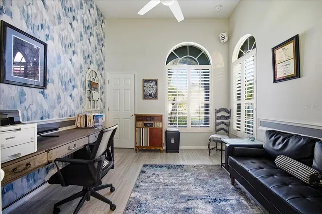 a living room with furniture gym equipment and a large window