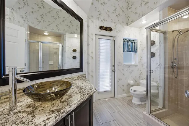 a living room with furniture a flat screen tv and a window