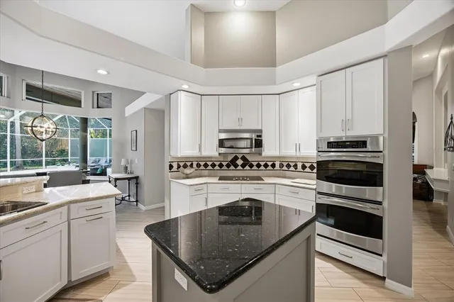 an aerial view of residential house with outdoor space and trees all around