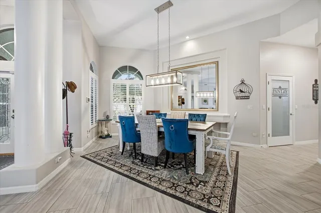 a living room with furniture a table and wooden floor