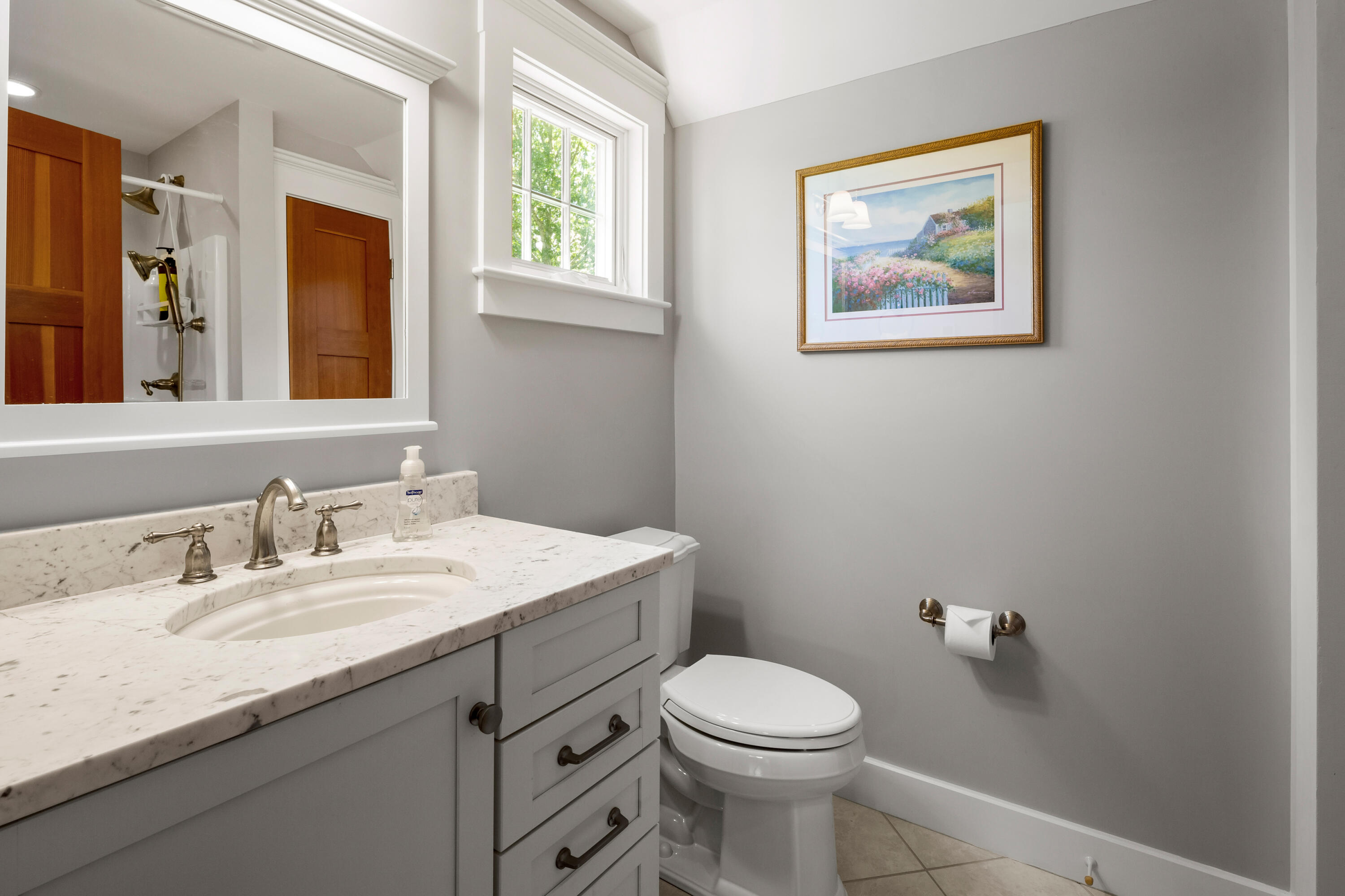 91 Pochet Road Orleans, MA 02653 - Photo 57 of 77 a bathroom with a granite countertop toilet sink and mirror