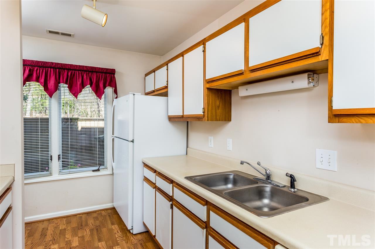 4225 Sunscape Lane Raleigh, NC 27613 - Photo 13 of 23 a kitchen that has a sink and a large window