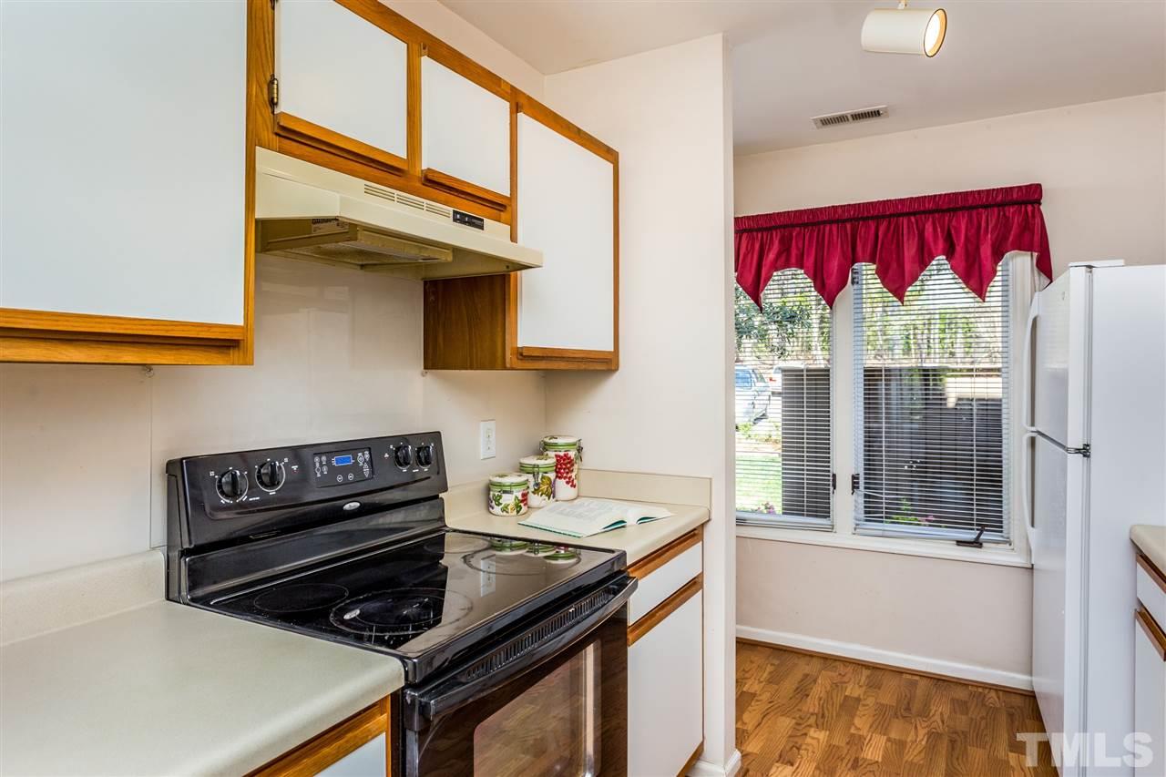 4225 Sunscape Lane Raleigh, NC 27613 - Photo 14 of 23 a kitchen that has a stove and a window