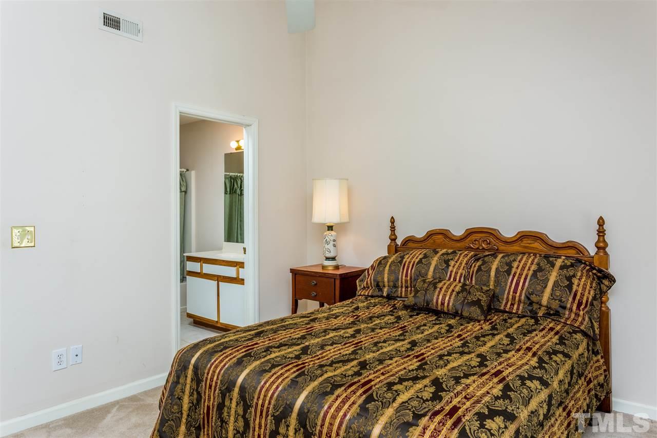 4225 Sunscape Lane Raleigh, NC 27613 - Photo 16 of 23 a bedroom with a bed and a lamp