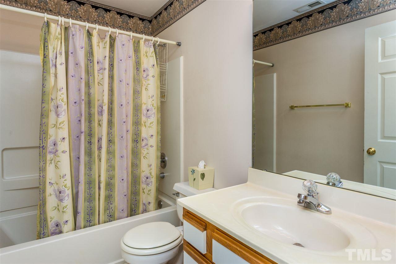 4225 Sunscape Lane Raleigh, NC 27613 - Photo 19 of 23 a bathroom with a sink toilet and shower
