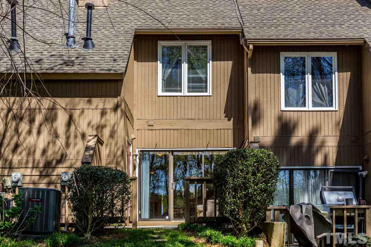 4225 Sunscape Lane Raleigh, NC 27613 - Photo 22 of 23 a front view of a house with glass windows and plants