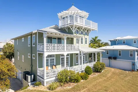 a view of a room with wooden floor and windows