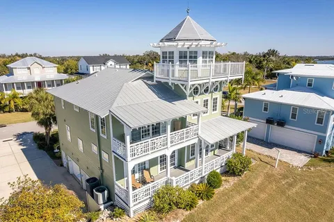 a view of a dining room with furniture a chandelier and wooden floor