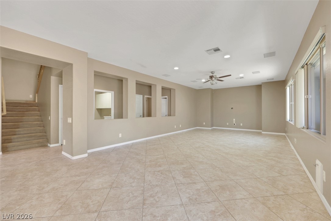 2501 Bechamel Place Henderson, NV 89044 - Photo 11 of 50 A spacious common area with warm-toned tile flooring and recessed lighting offers an inviting ambiance.