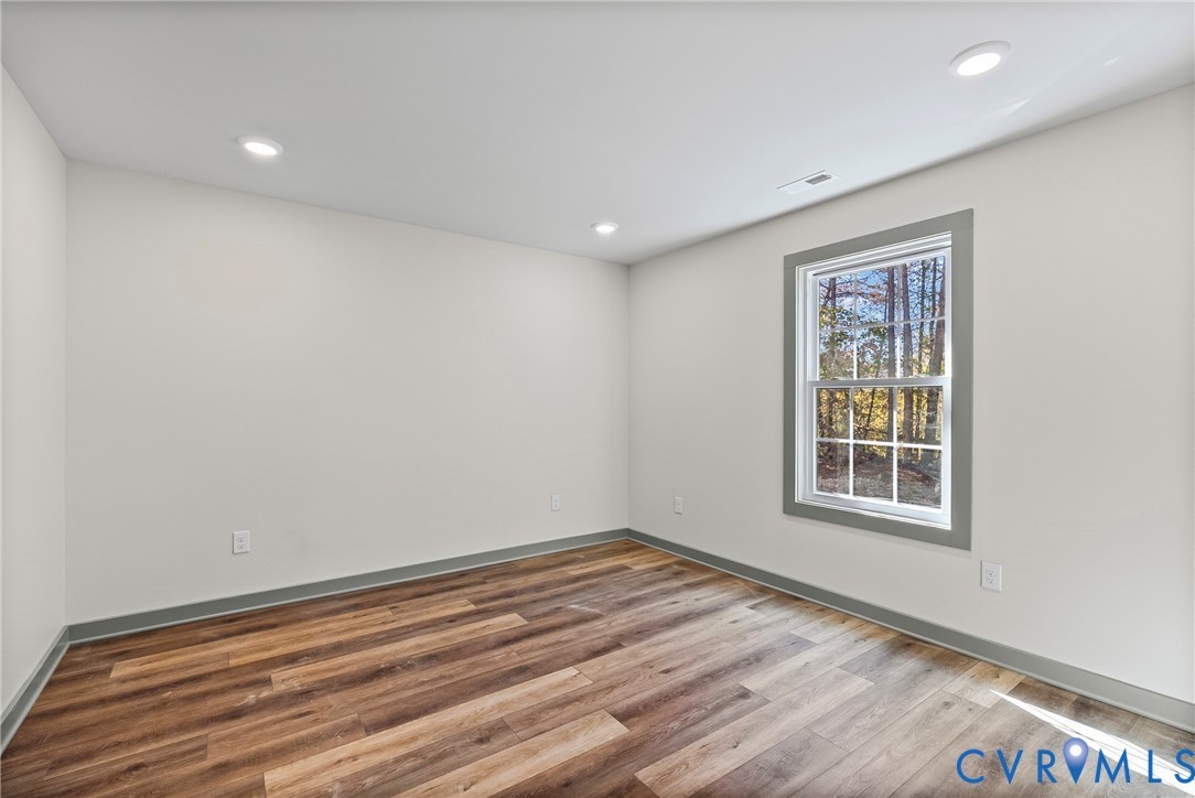 203 Zion Drive Farmville, VA 23901 - Photo 12 of 20 an empty room with wooden floor and windows