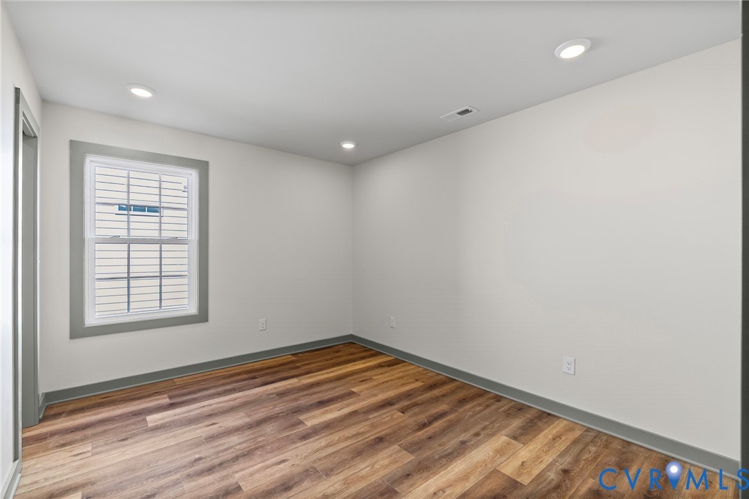 203 Zion Drive Farmville, VA 23901 - Photo 15 of 20 an empty room with wooden floor and windows