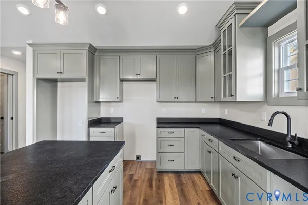 a kitchen with granite countertop a stove and a sink