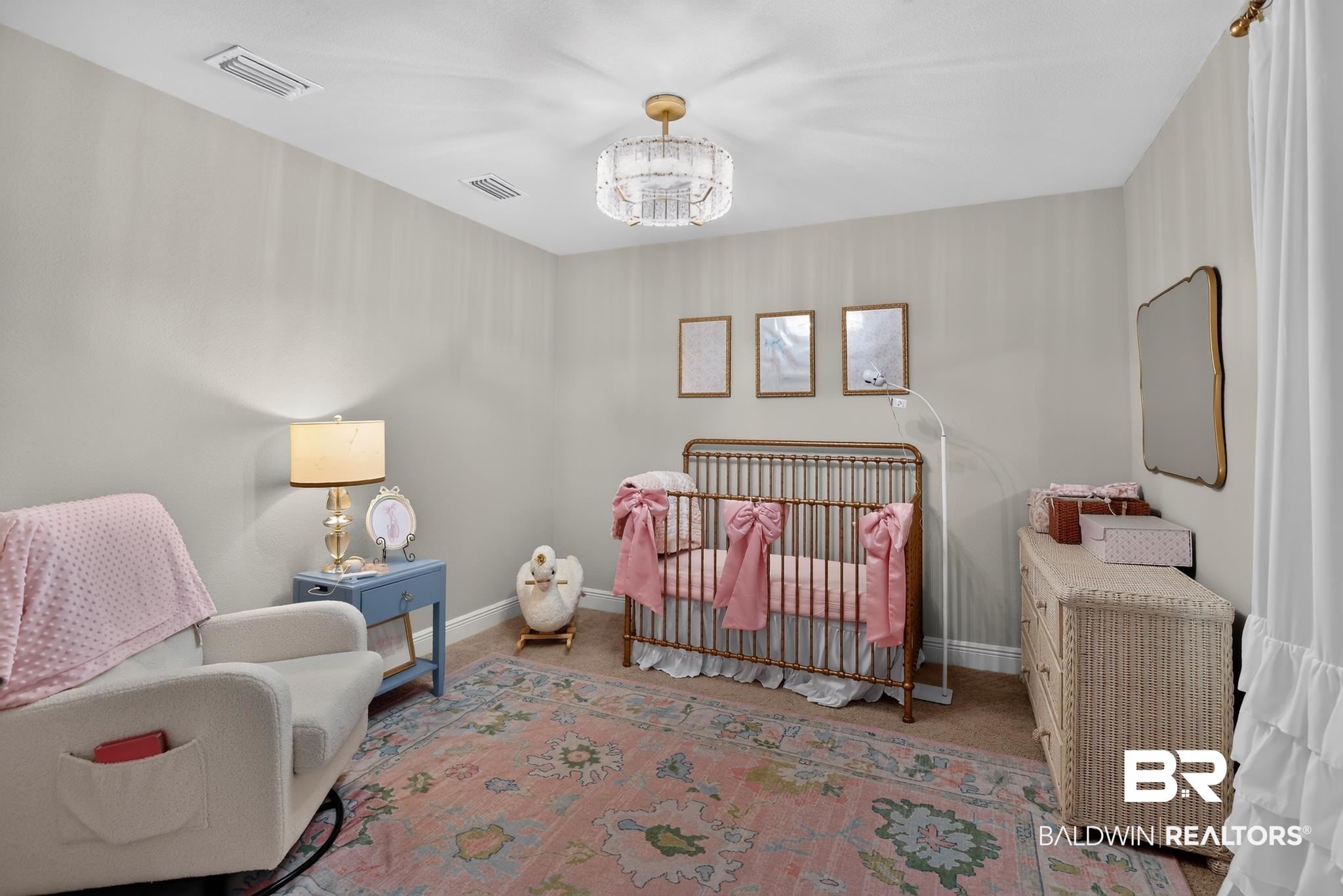 1210 Primrose Lane Foley, AL 36535 - Photo 21 of 33 Neutral-toned room featuring a decorative overhead light fixture, carpeted flooring, and white baseboards