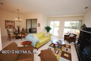 14 Cove Road Ponte Vedra Beach, FL 32082 - Photo 4 of 18 a living room with furniture a flat screen tv and a large window