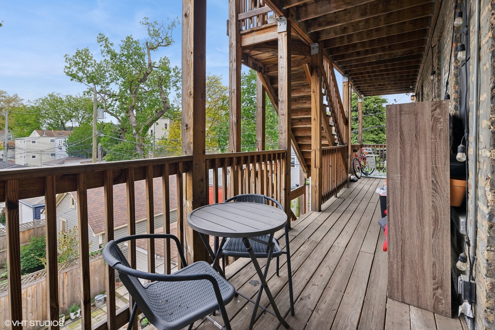2709 West Altgeld Street, Unit 2 Chicago, IL 60647 - Photo 13 of 13 a view of a balcony with chairs and wooden floor