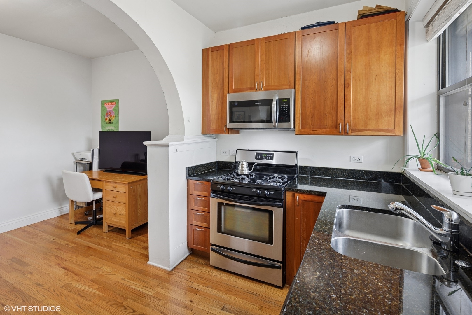 2709 West Altgeld Street, Unit 2 Chicago, IL 60647 - Photo 8 of 13 a kitchen with a stove a sink and a microwave