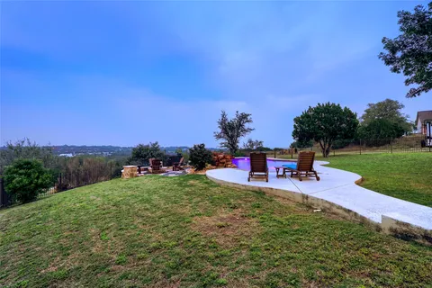 a view of a house with a yard and sitting area