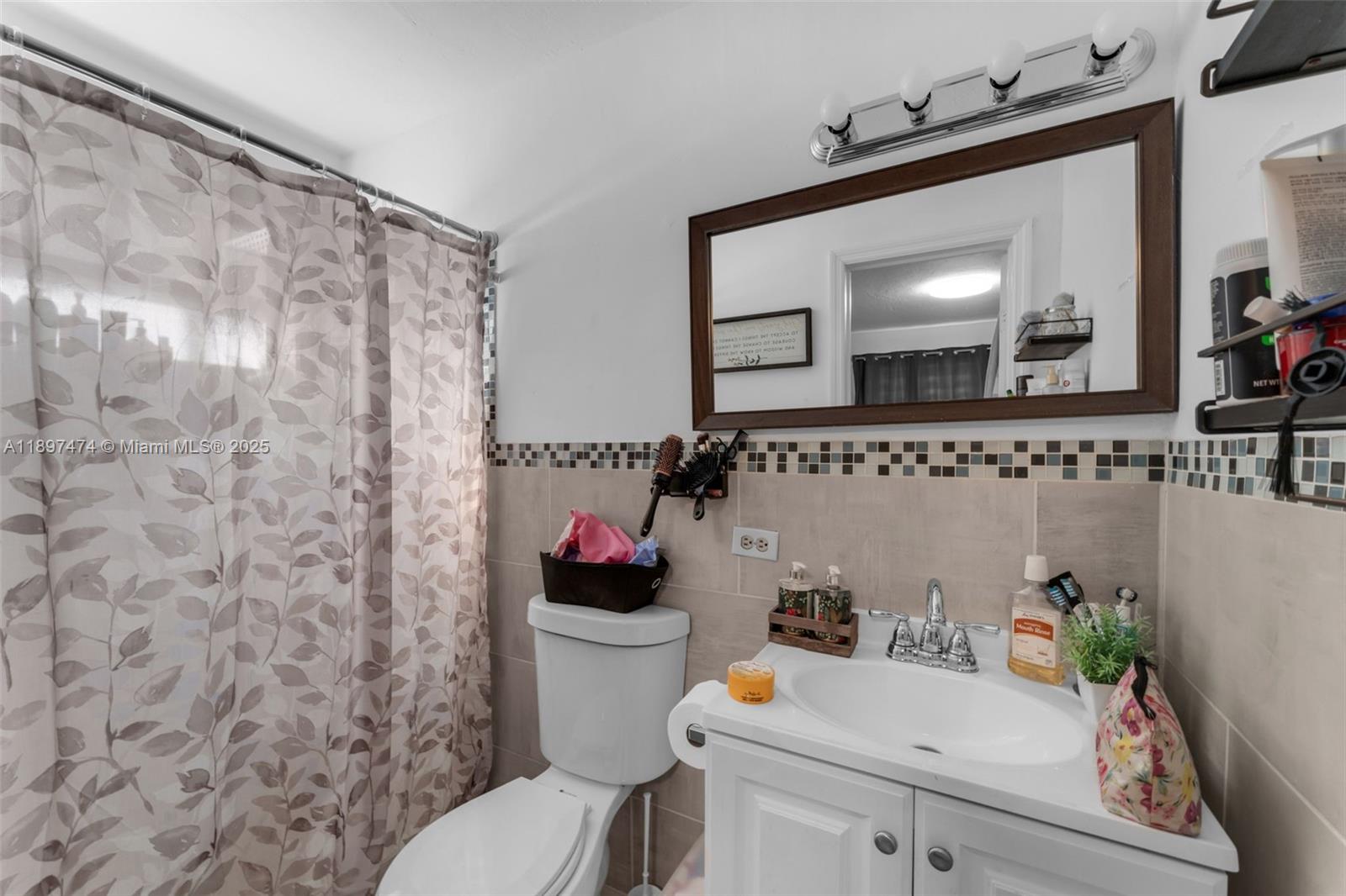 8811 Southwest 128th Street Miami, FL 33176 - Photo 19 of 28 a bathroom with a sink and a mirror with toilet