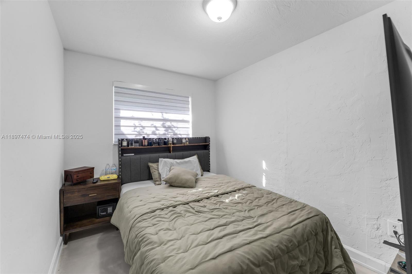 8811 Southwest 128th Street Miami, FL 33176 - Photo 23 of 28 a bedroom with a bed and a window