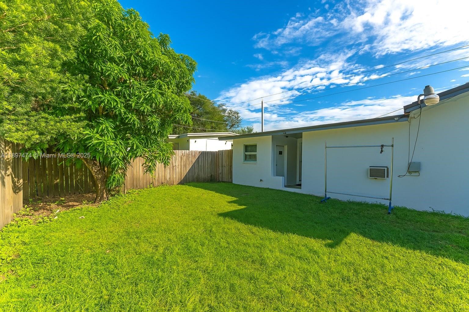 8811 Southwest 128th Street Miami, FL 33176 - Photo 27 of 28 a backyard of a house with plants and large tree