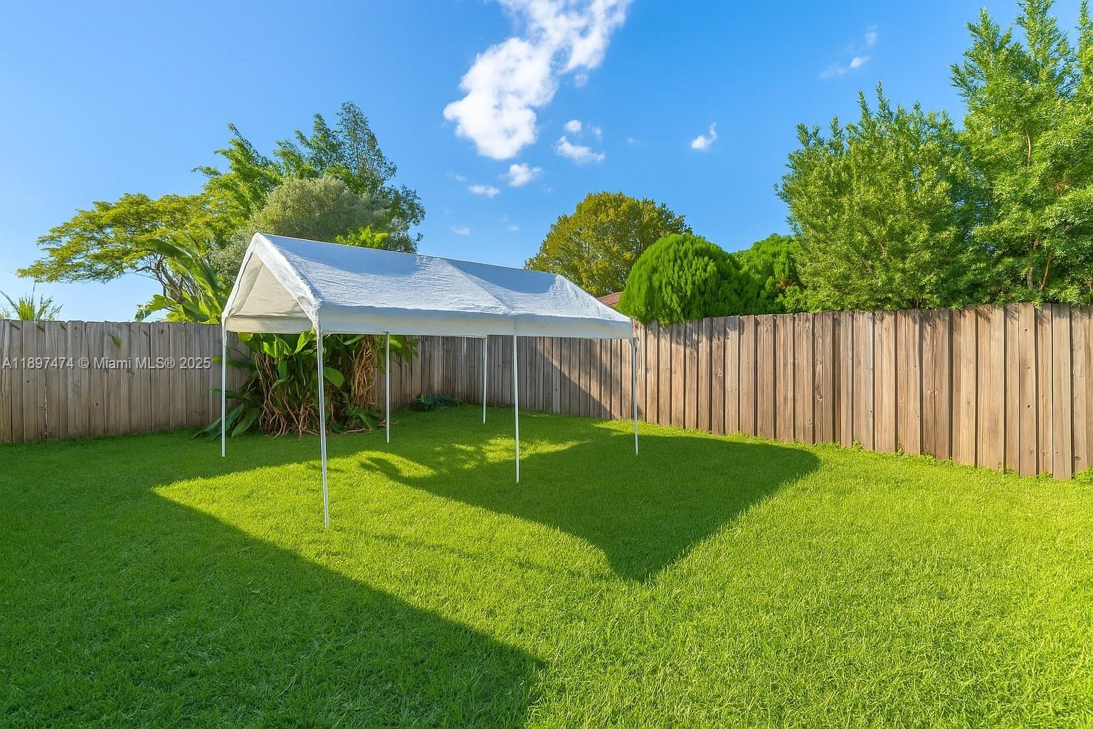 8811 Southwest 128th Street Miami, FL 33176 - Photo 28 of 28 a view of a house with a backyard and a tree