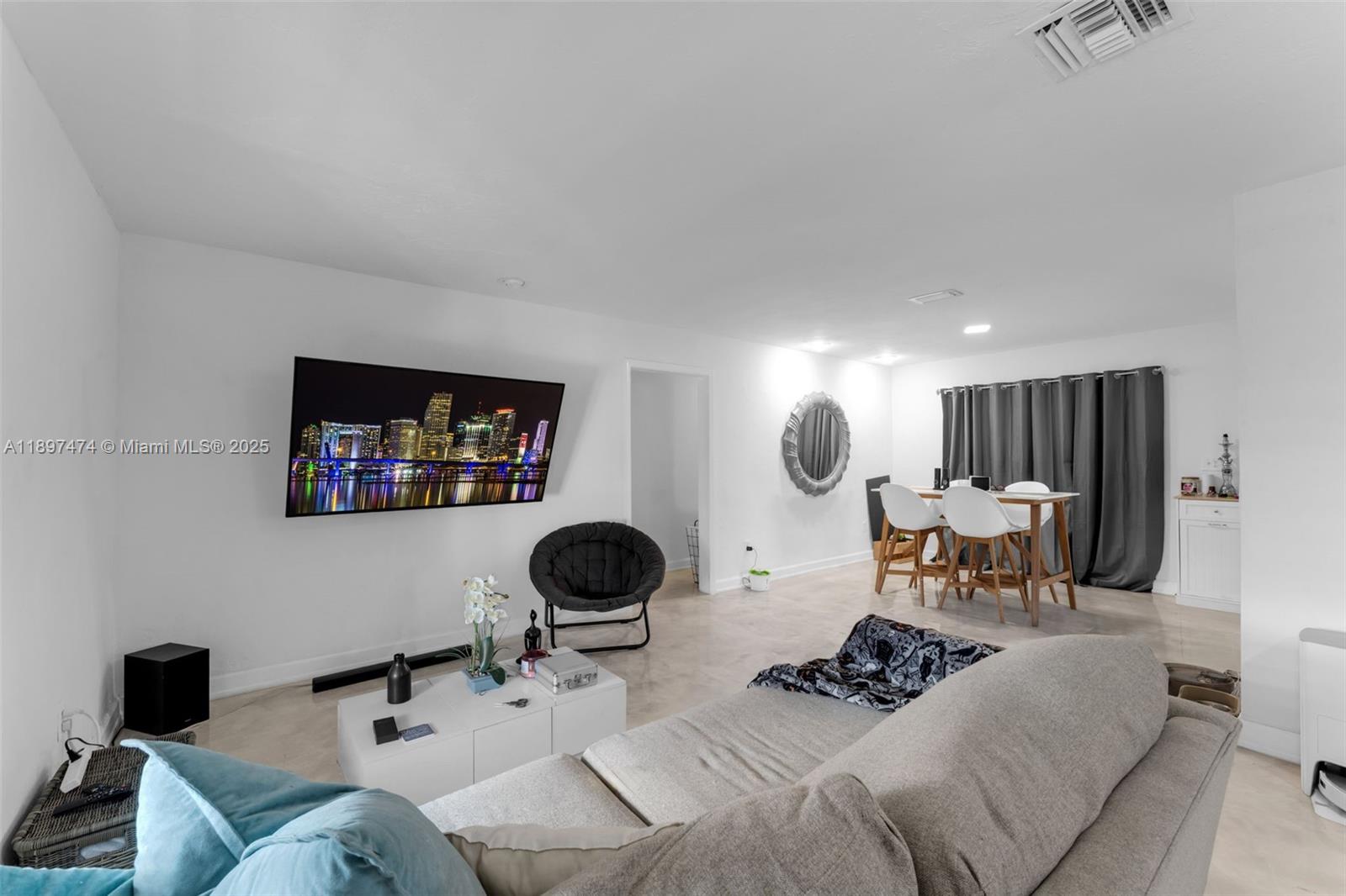8811 Southwest 128th Street Miami, FL 33176 - Photo 9 of 28 a living room with furniture and a flat screen tv