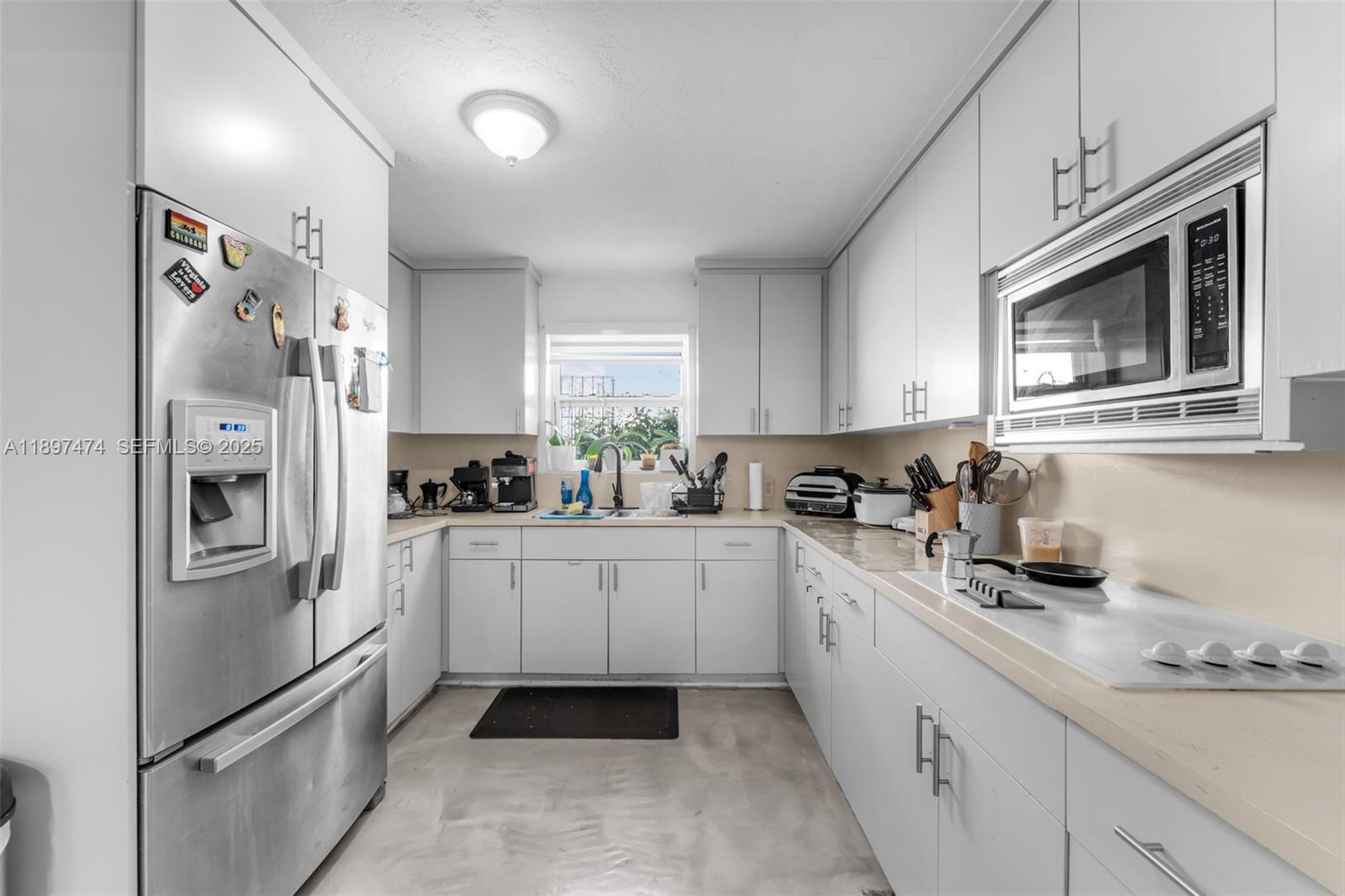 8811 Southwest 128th Street Miami, FL 33176 - Photo 10 of 28 a kitchen with stainless steel appliances granite countertop a refrigerator sink and cabinets